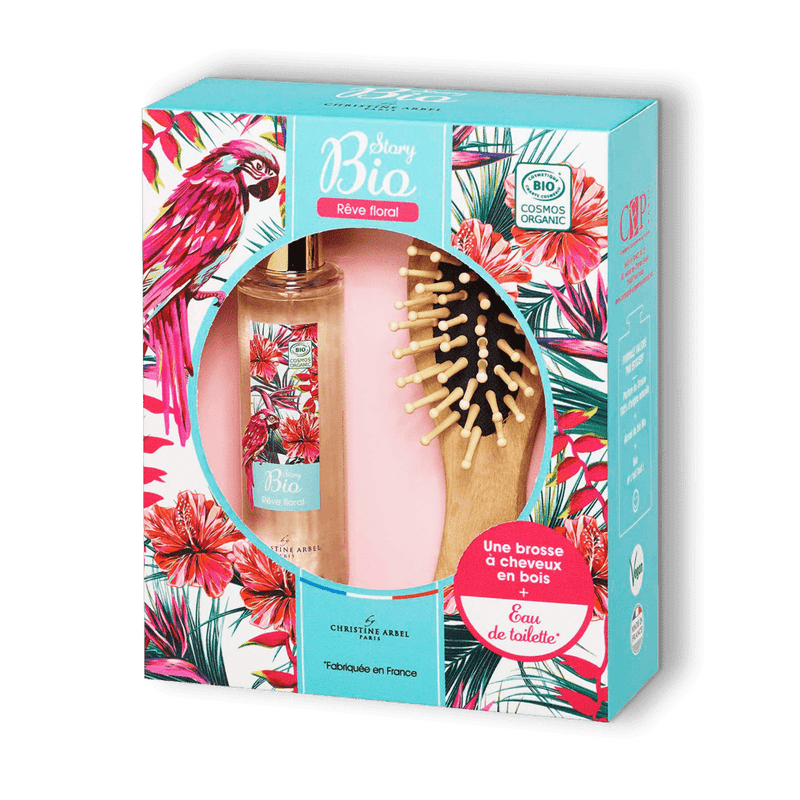 Sur fond transparent un coffret cadeau parfum pour femme Story Bio Rêve Floral avec une eau de toilette et une brosse en bambou
