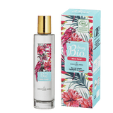 Sur un fond transparent, le flacon en verre de l'eau de toilette pour femme Rêve Floral dans la gamme Story Bio de la marque Christine Arbel. A sa droite, son étui en carton.