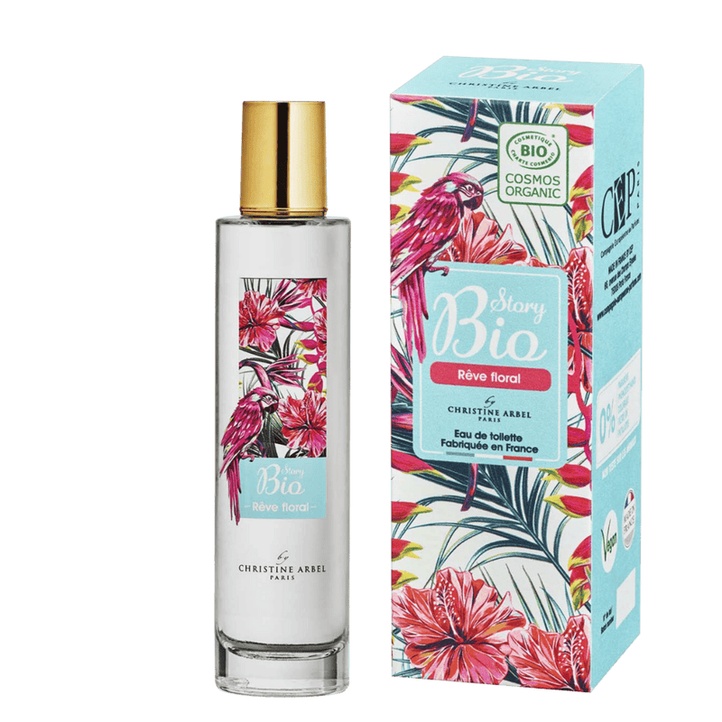 Sur un fond transparent, le flacon en verre de l'eau de toilette pour femme Rêve Floral dans la gamme Story Bio de la marque Christine Arbel. A sa droite, son étui en carton.