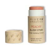 Sur fond transparent, un blush en stick de la marque River Organics en teinte Peachy